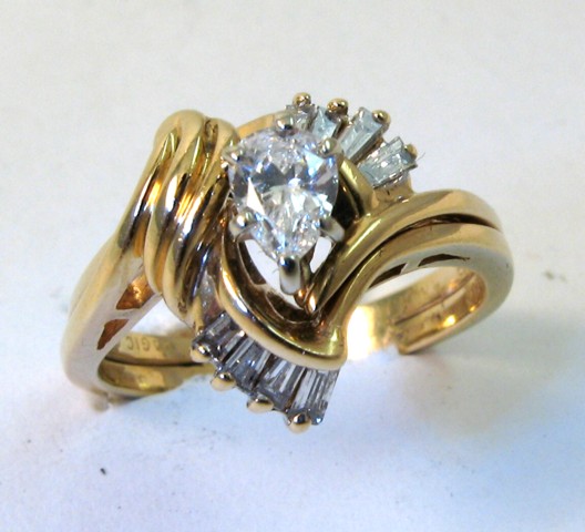 Appraisal: DIAMOND AND FOURTEEN KARAT GOLD RING set with a pear-cut