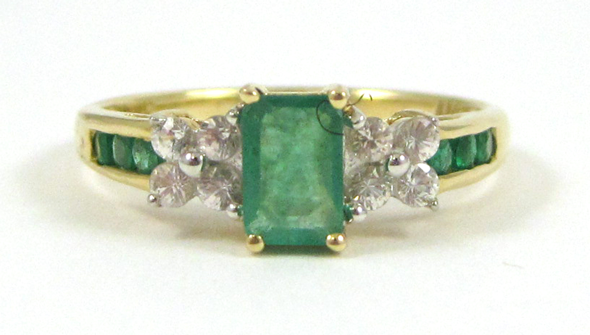 Appraisal: EMERALD AND FOURTEEN KARAT GOLD RING with three round-cut green