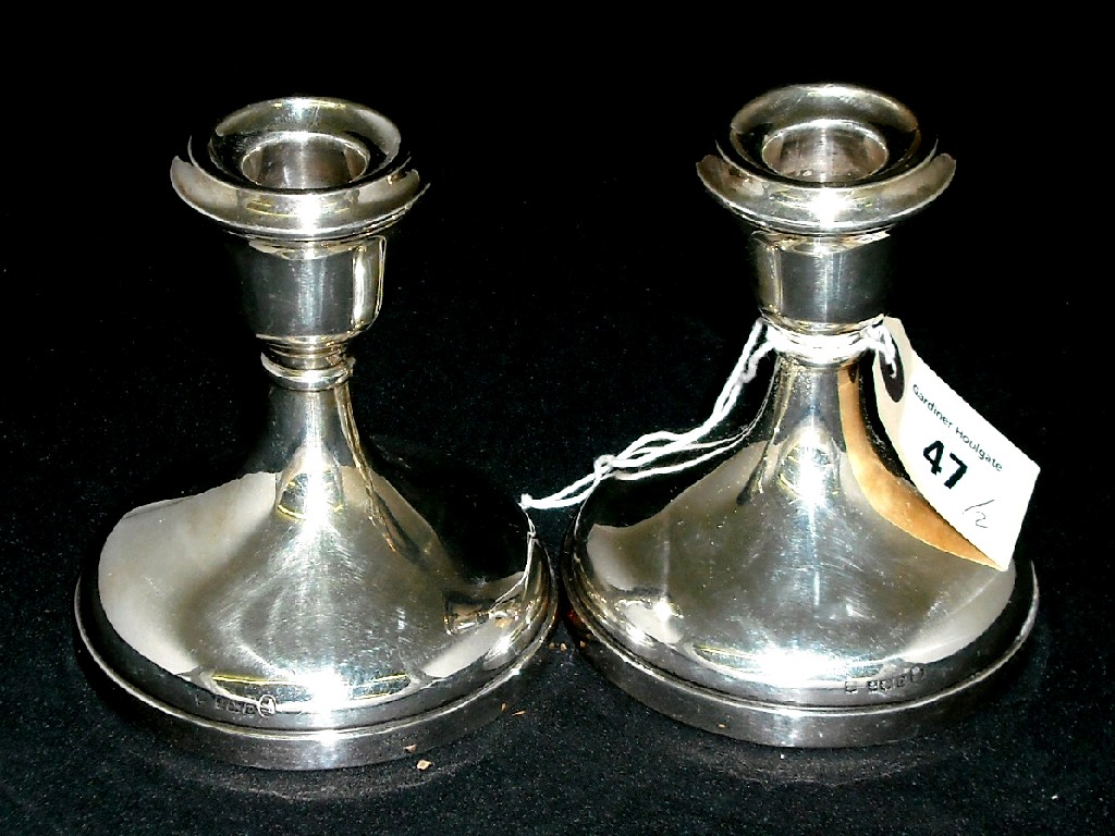 Appraisal: Pair of squat candlesticks of plain circular form with loaded