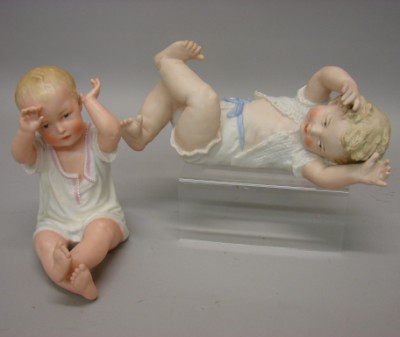 Appraisal: Pair of bisque Heubach piano babies Sitting figure has hands