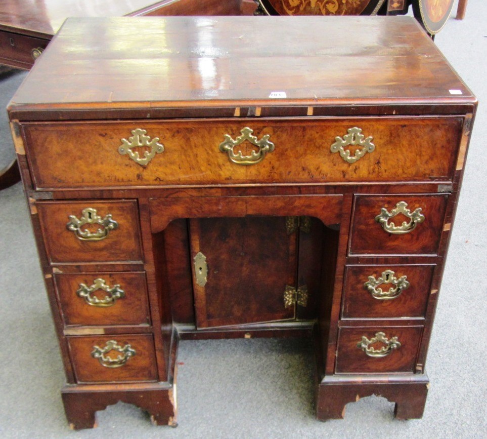 Appraisal: An th century figured walnut kneehole writing desk on bracket