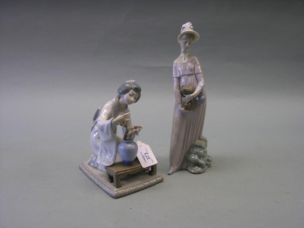 Appraisal: Two Lladro figures tall lady holding small dog in kneeling