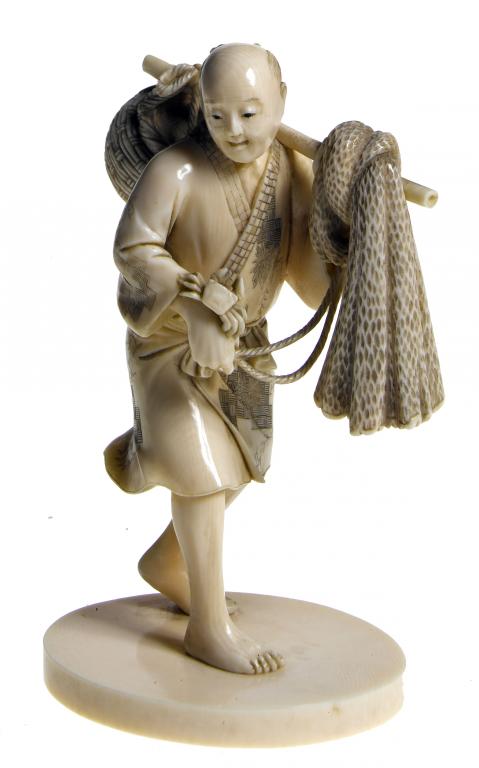 Appraisal: AN IVORY FIGURE OF A FISHERMAN a crab in his