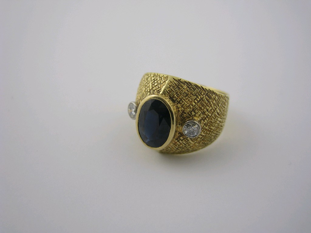 Appraisal: A Continental Sapphire and Diamond Ring the textured band rub-over