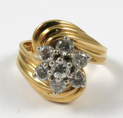 Appraisal: DIAMOND AND FOURTEEN KARAT GOLD RING set with a cluster