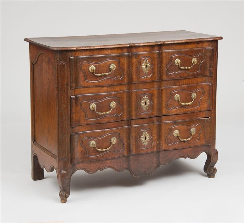 Appraisal: EARLY LOUIS XV PROVINCIAL STAINED FRUITWOOD BRASS-MOUNTED COMMODE The overhanging