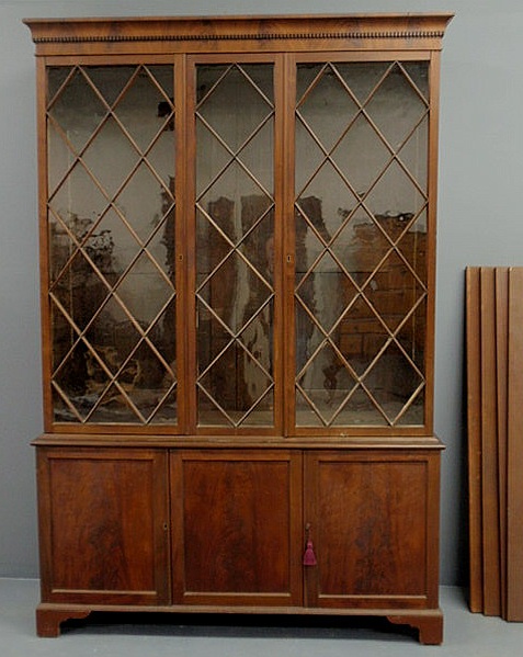 Appraisal: Mahogany two-part bookshelf cabinet with a dentil molded cornice above