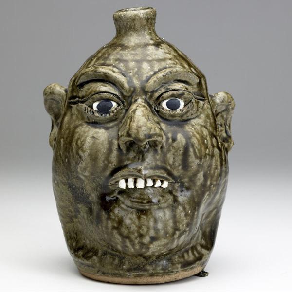 Appraisal: LANIER MEADERS Face jug with smiling expression and clay teeth