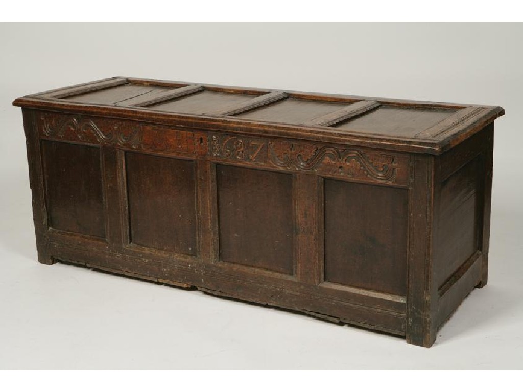 Appraisal: A CHARLES II OAK COFFER with a four panelled top