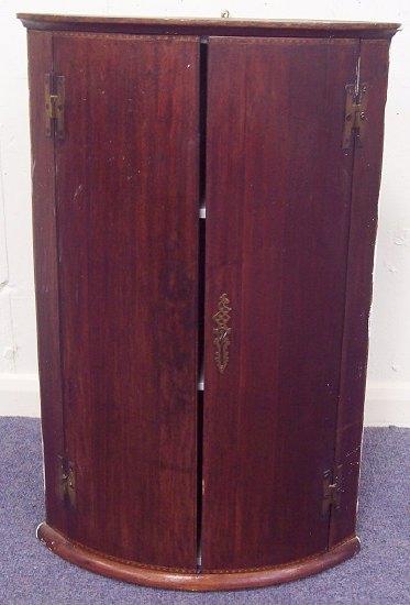 Appraisal: A mahogany bowfront corner cupboard with brass H hinges cm