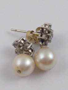 Appraisal: A pair of cultured pearl and diamond earrings the pearls