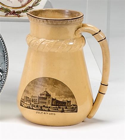 Appraisal: Black transfer-decorated yellow ware Centennial pitcher circa Of tapering form