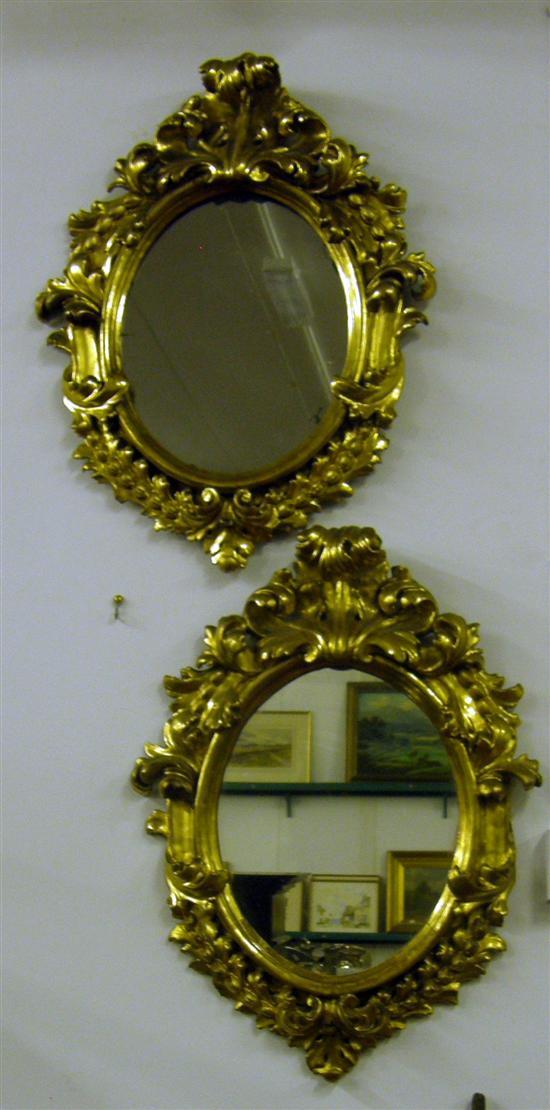 Appraisal: A PAIR OF ITALIAN GILTWOOD SHAPED OVAL MIRRORS probably th