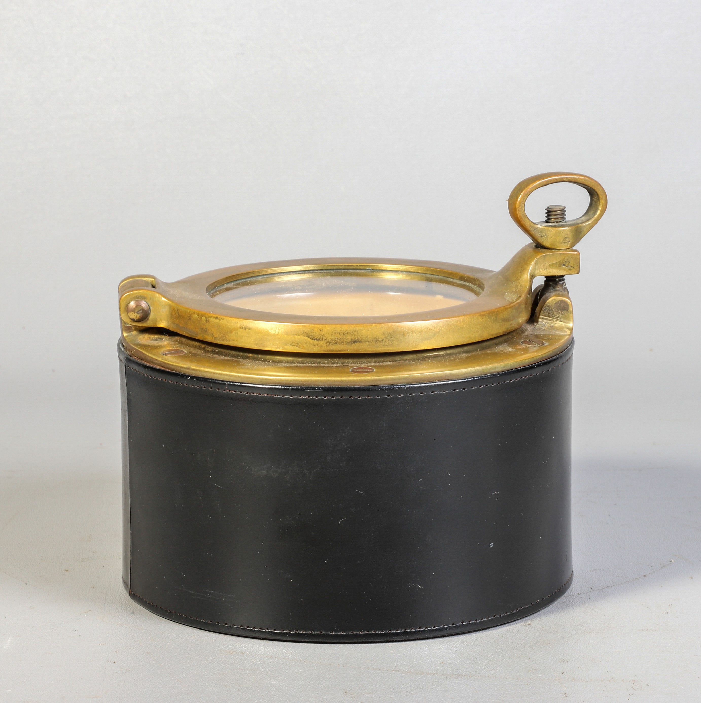 Appraisal: Leather brass porthole humidor tobacco jar made in England -