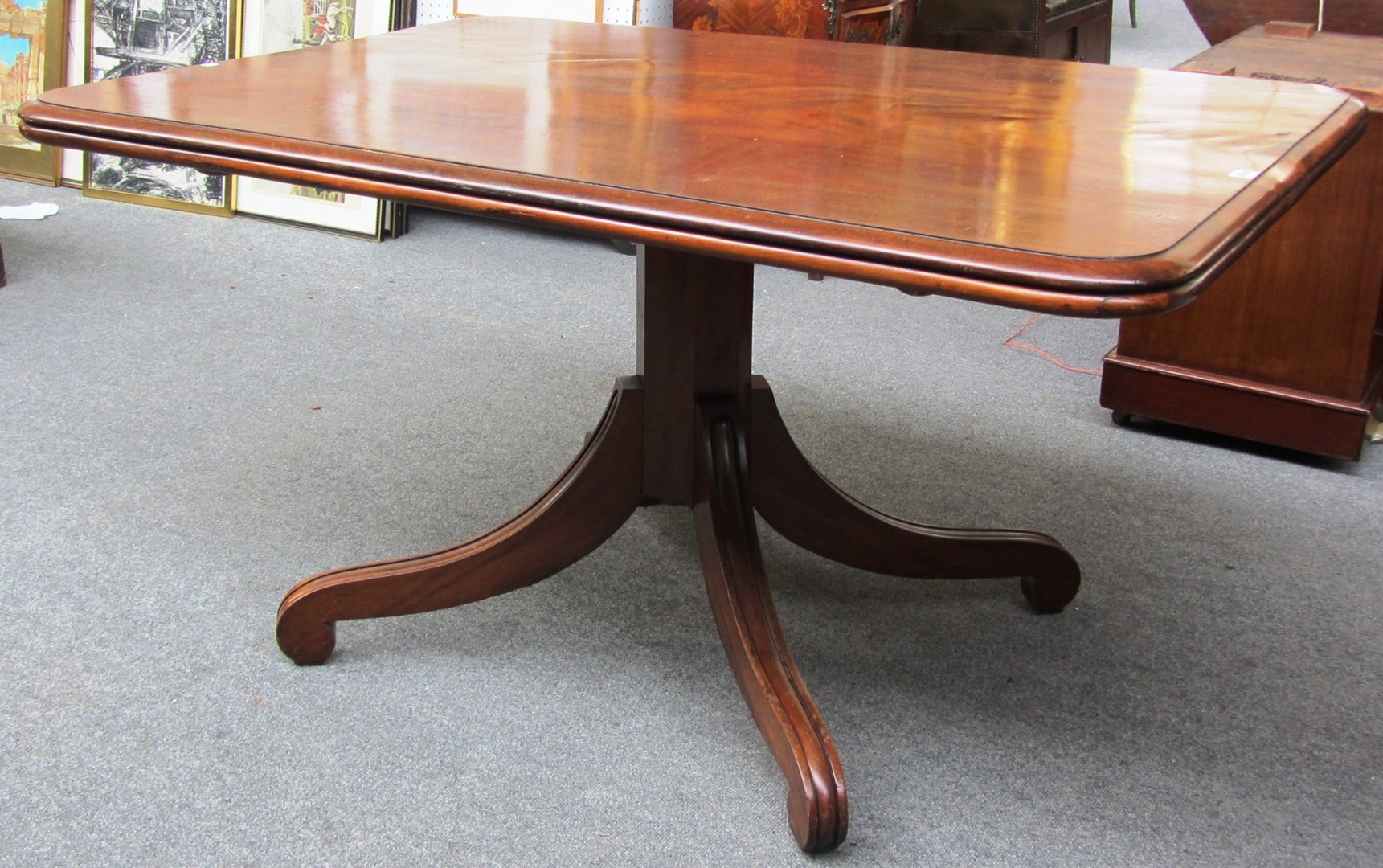 Appraisal: A Regency mahogany rectangular snap-top breakfast table on four downswept