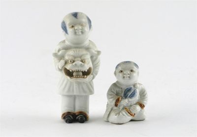 Appraisal: Two small Japanese Hirado figures one of a seated boy