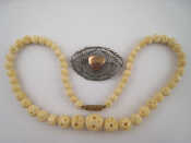 Appraisal: A mixed lot comprising a carved bead necklace and a