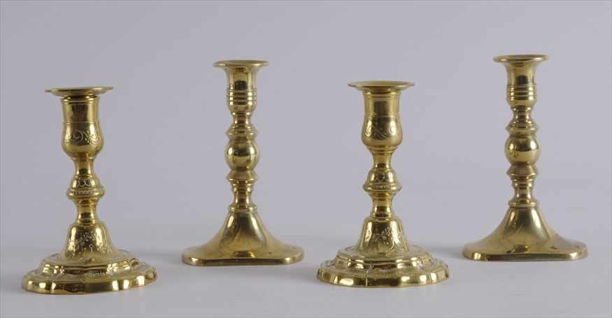 Appraisal: TWO PAIRS OF BRASS CANDLESTICKS The first in the R