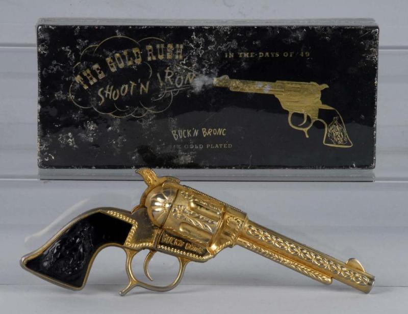 Appraisal: Gold Buck N Bronc Cap Gun Description Manufactured by George