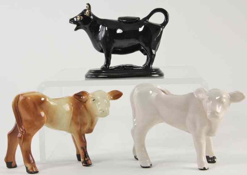 Appraisal: Three Cow Figuresincluding two planters and one black and gilt