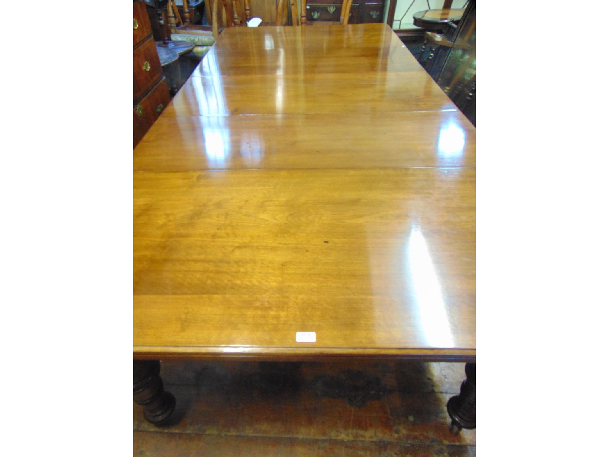 Appraisal: A substantial Victorian mahogany extending dining table with three additional