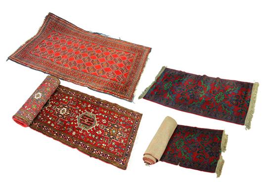 Appraisal: FOUR ORIENTAL RUGS Twentieth century Two similar runners in dark