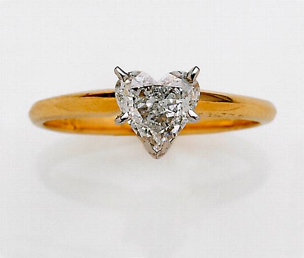 Appraisal: A heart-shaped diamond and fourteen karat gold solitaire ring