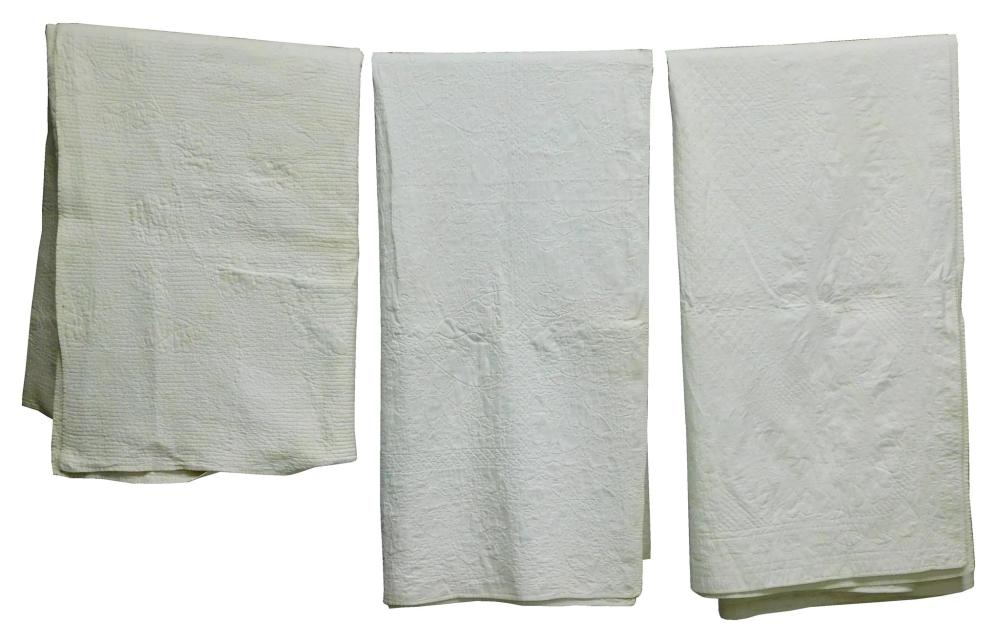 Appraisal: TEXTILES Three white work whole cloth quilts two th C