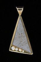 Appraisal: k Gold Pendant set with a Meteorite A flat obtuse