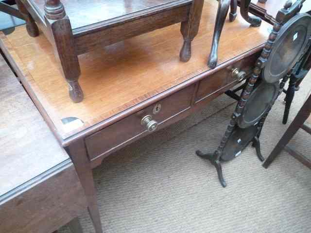 Appraisal: A MAHOGANY TWO DRAWER SIDE TABLE with cross banded decoration