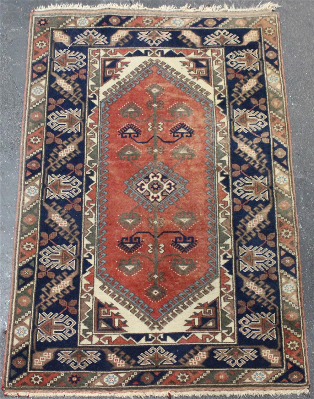 Appraisal: TRIBAL WOOL RUG having an abstract floral design radiating from