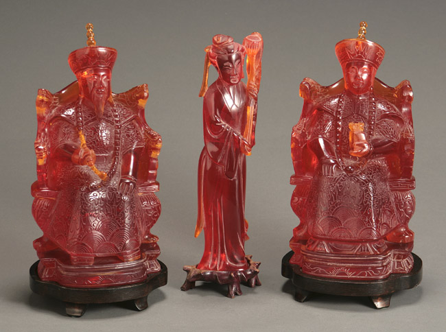 Appraisal: Pair of Chinese Cherry-Red Amber Figures of Enthroned Official and