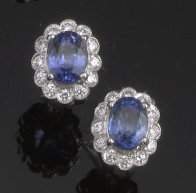 Appraisal: A pair of sapphire and diamond cluster earrings Set in