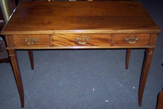 Appraisal: A mahogany writing table fitted three drawers on square taper