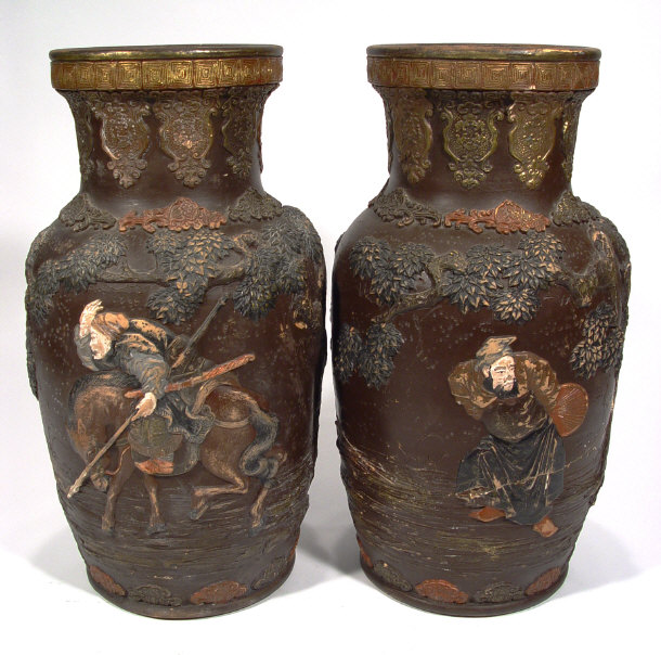 Appraisal: Pair of Oriental pottery vases relief mouled with figures and