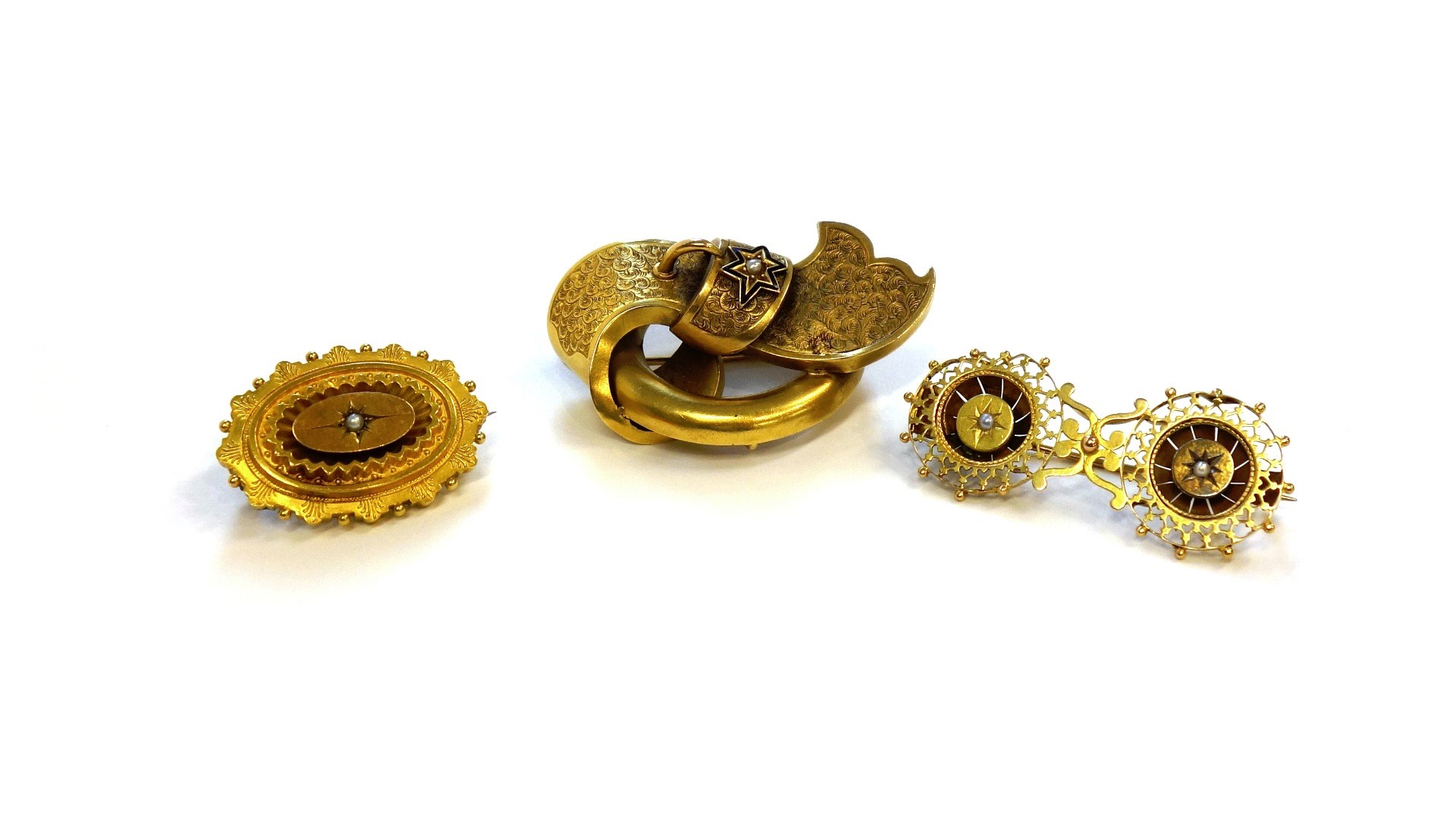 Appraisal: A Victorian gold brooch in a circular and strap design