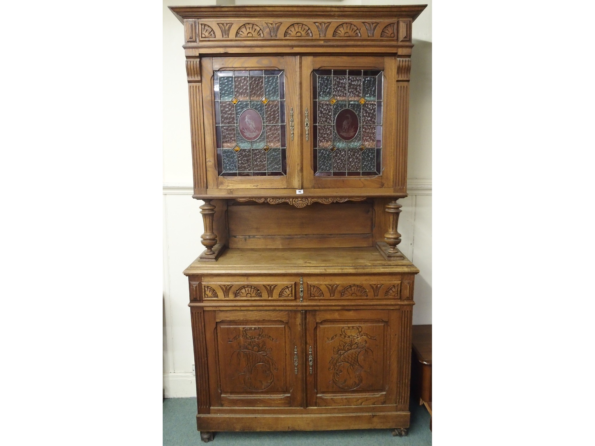 Appraisal: A th Century oak cabinet with leaded glass doors over