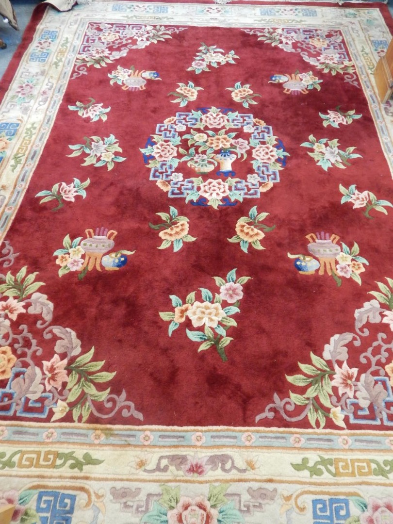 Appraisal: A large Chinese cut wool carpet decorated with urns flowers