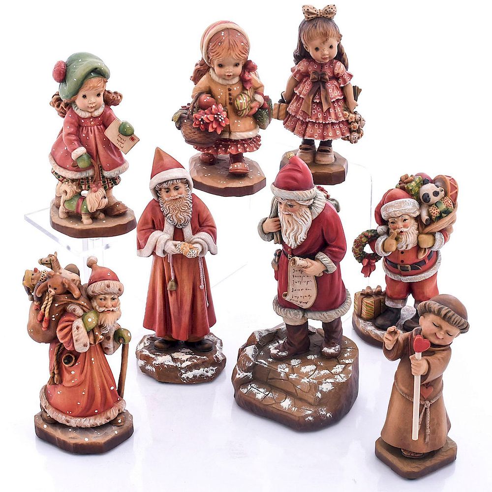 Appraisal: CARVED WOOD ANRI FIGURINES Christmas themed decorative wood carvings Comes