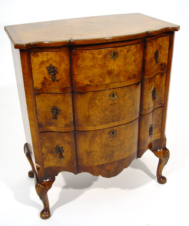 Appraisal: Reproduction burr walnut chest fitted three serpentine fronted graduated drawers