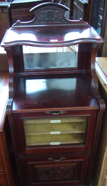 Appraisal: An Edwardian mahogany music cabinet the carved ledge back over