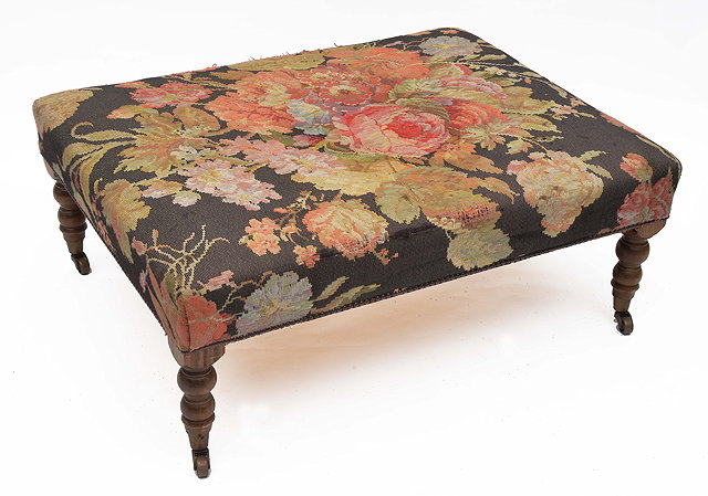 Appraisal: A RECTANGULAR OVERSTUFFED UPHOLSTERED STOOL on turned tapering legs terminating