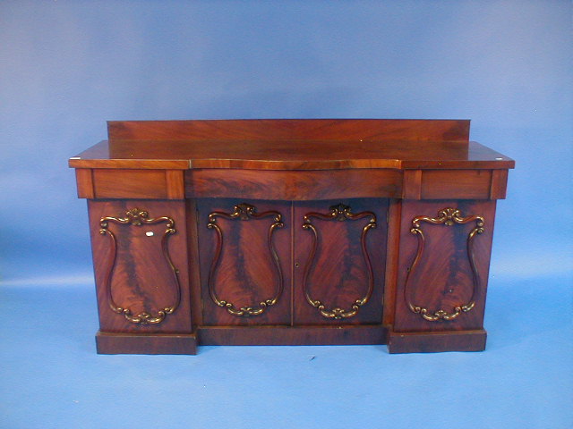 Appraisal: A Victorian flamed mahogany serpentine sideboard with door base with