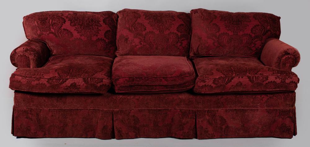 Appraisal: CONTEMPORARY UPHOLSTERED SOFA the rectangular loose cushion back outscrolling arms