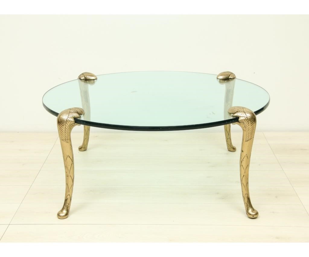 Appraisal: Heavy glass round coffee table with brass palm tree legs