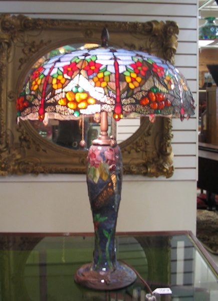 Appraisal: A TIFFANY STYLE STAINED AND LEADED GLASS TABLE LAMP Hand