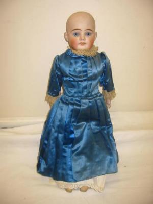 Appraisal: A German bisque shoulder head girl doll with fixed blue