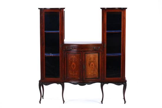 Appraisal: EDWARDIAN MAHOGANY DOUBLE VITRINE CABINET circa Matching serpentine molded-edge vitrine