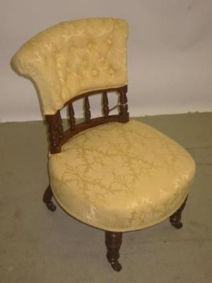 Appraisal: A VICTORIAN WALNUT NURSING CHAIR button upholstered in yellow damask