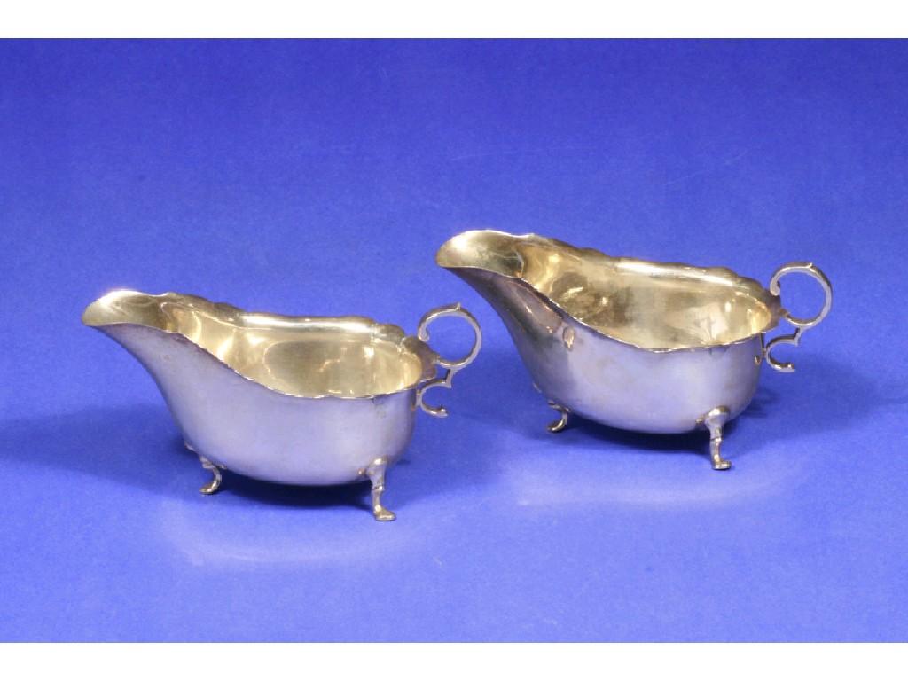 Appraisal: A PAIR OF SAUCEBOATS of shaped oval form with scroll